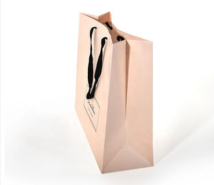La manija plana del algodón crea las bolsas de papel para requisitos particulares, color rosado de papel impreso de los bolsos de compras proveedor