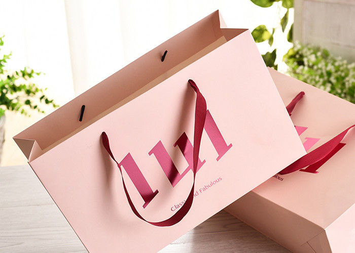 Los bolsos de compras del papel de la manija de la cinta con pegamento a prueba de calor fuerte refuerzan proveedor